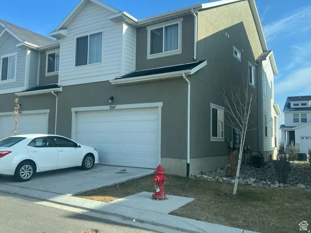 Modern townhome exterior featuring stucco and siding finishes