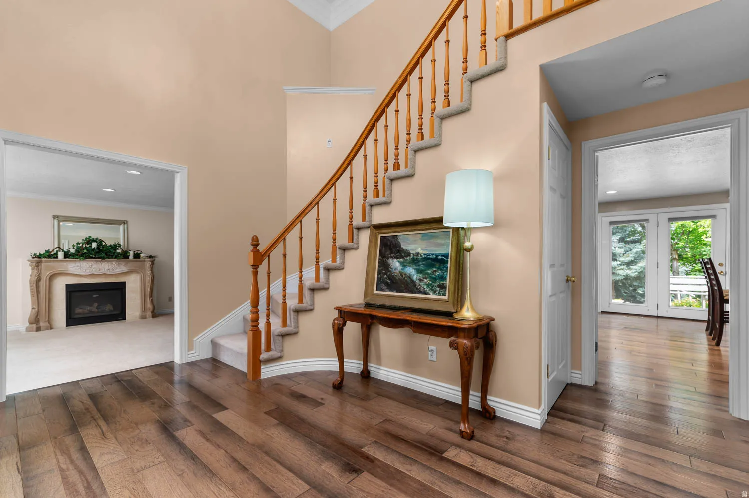 Grand foyer with wide plank wood-finish flooring