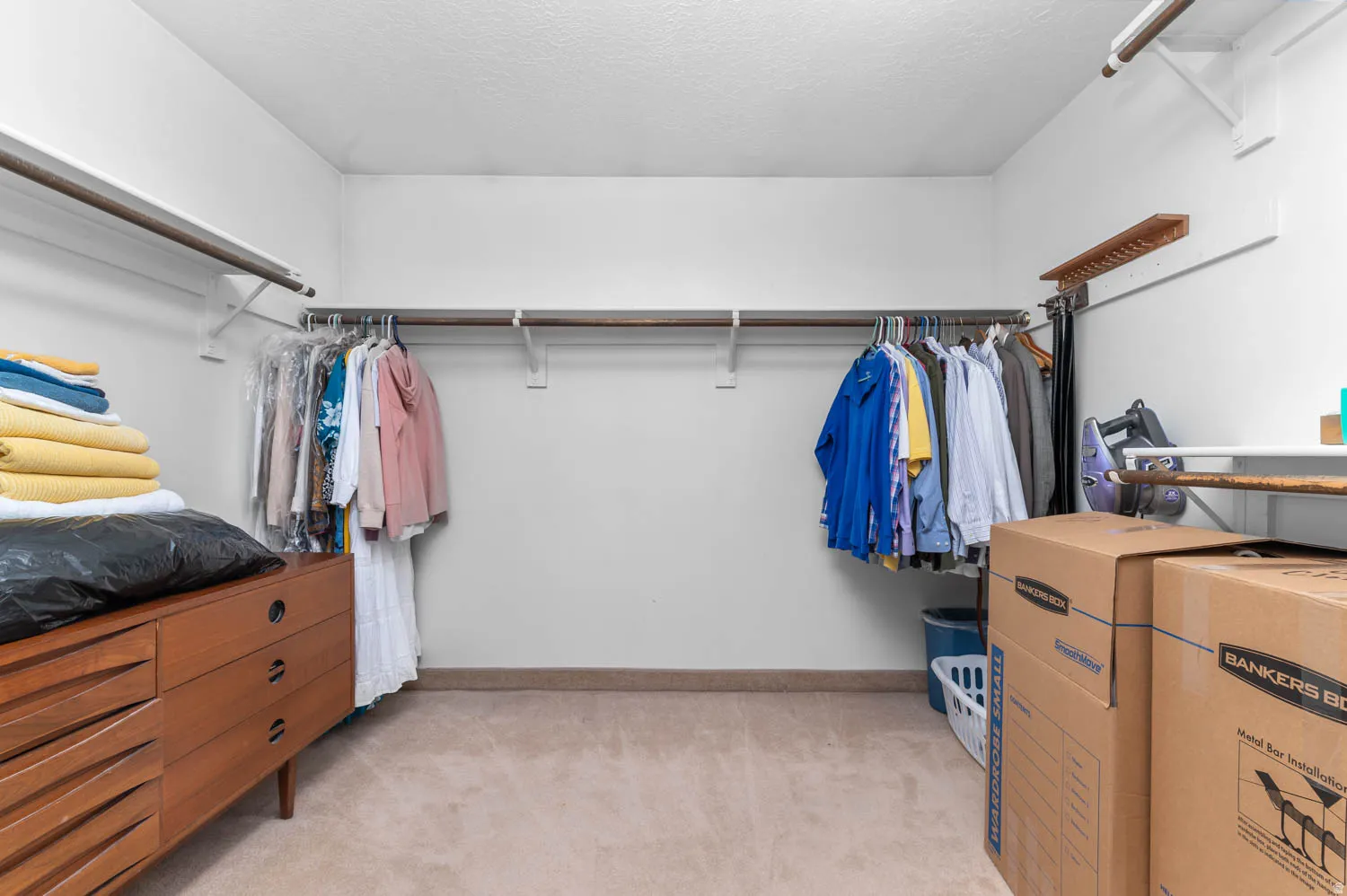 Spacious walk-in closet featuring multiple shelving units and clothing rods for ample organization