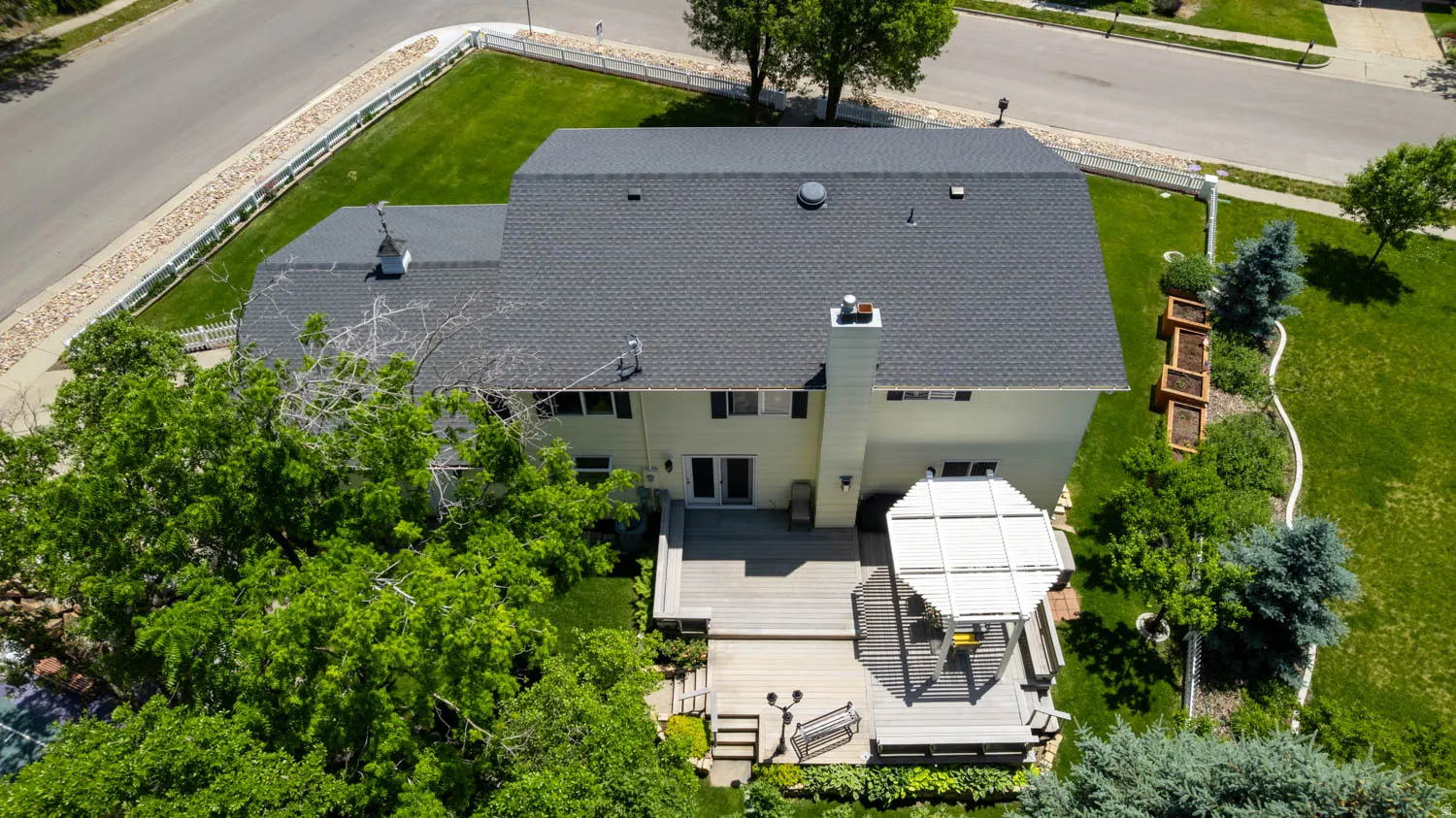 Spacious rear deck featuring a built-in pergola, multiple-level design, and direct access to interior