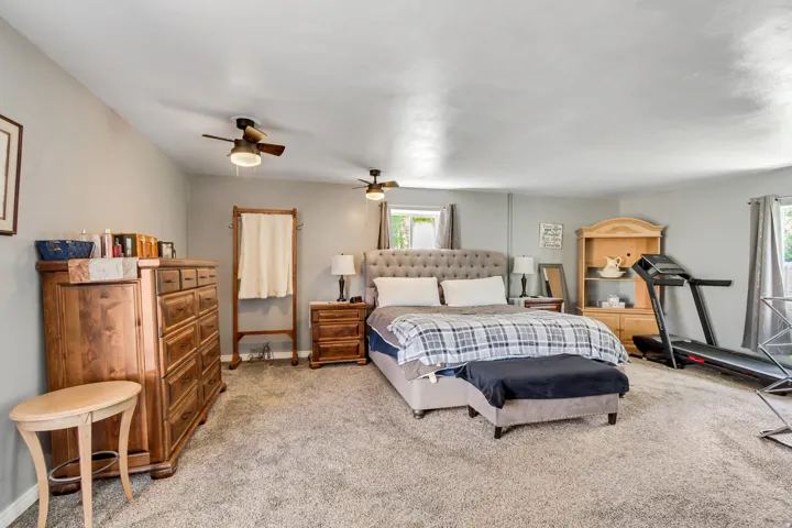 Spacious room featuring neutral wall tones and carpet flooring