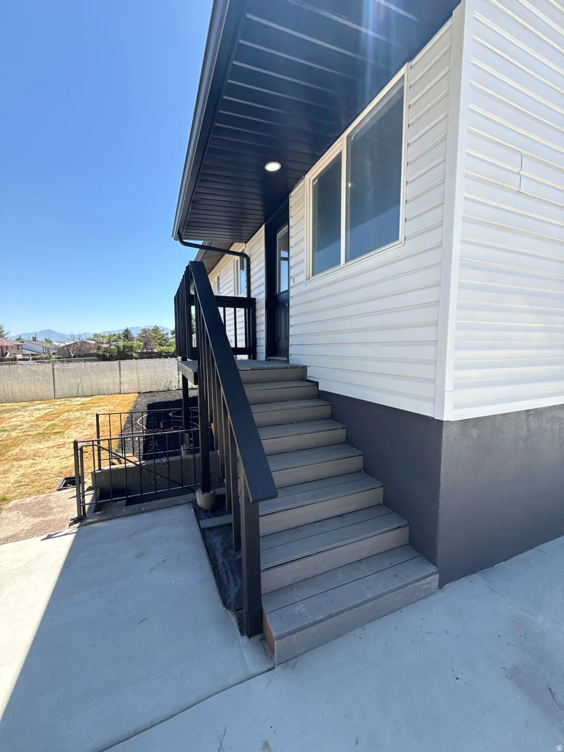 Exterior staircase with composite treads and black railings