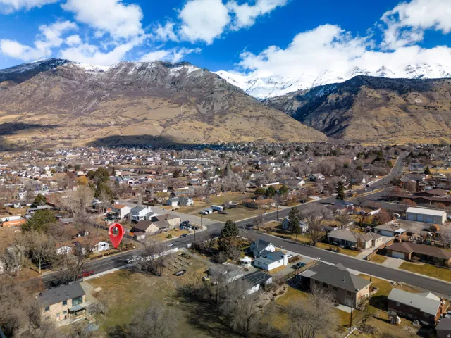 Aerial perspective showcasing a residential neighborhood with distant snow-capped mountains