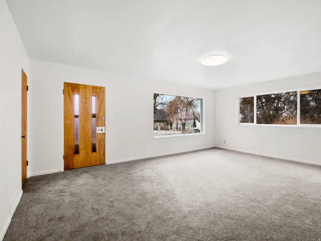 Entry area featuring a solid wood door with vertical glass inserts