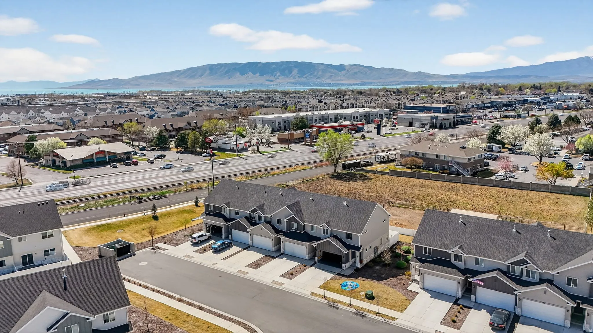 Modern townhome community featuring multi-story residences with attached garages and street-facing driveways