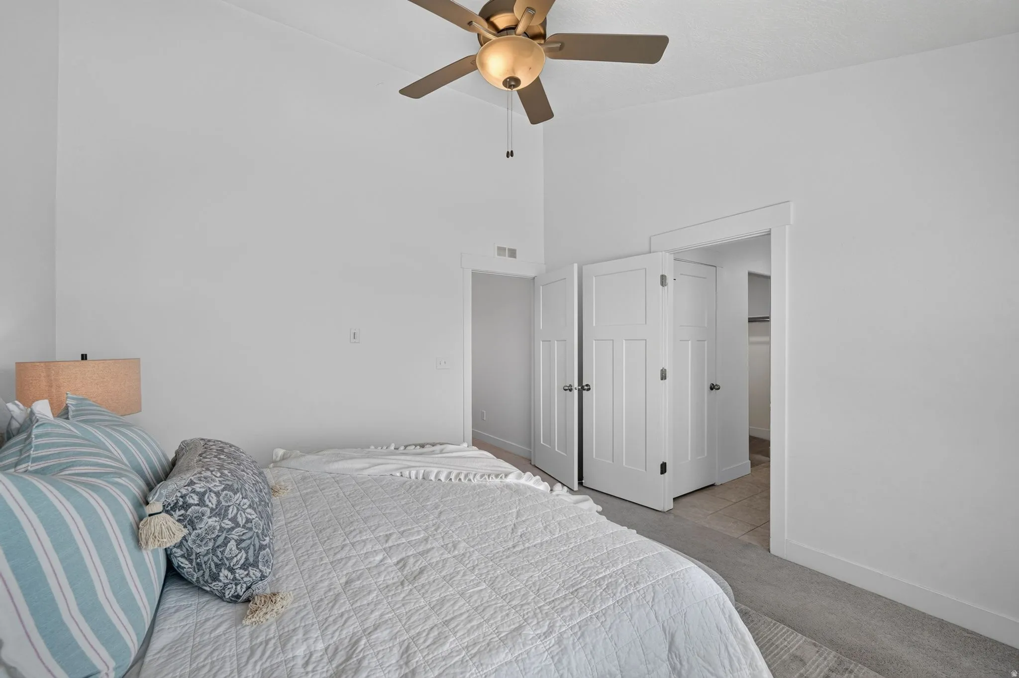 Neutral white walls and ceiling fan with integrated lighting