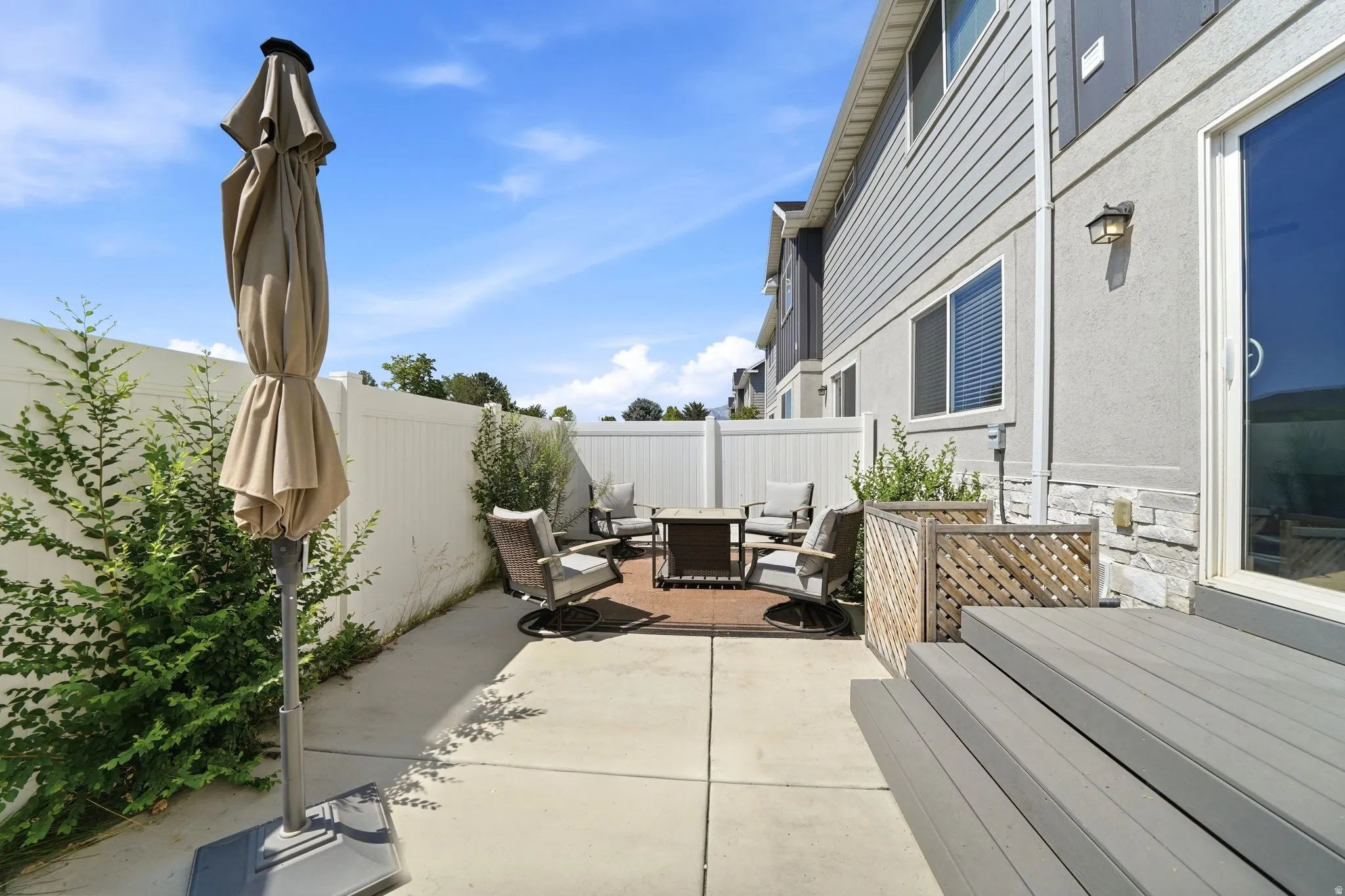 Private patio space featuring a concrete pad and a dedicated seating area