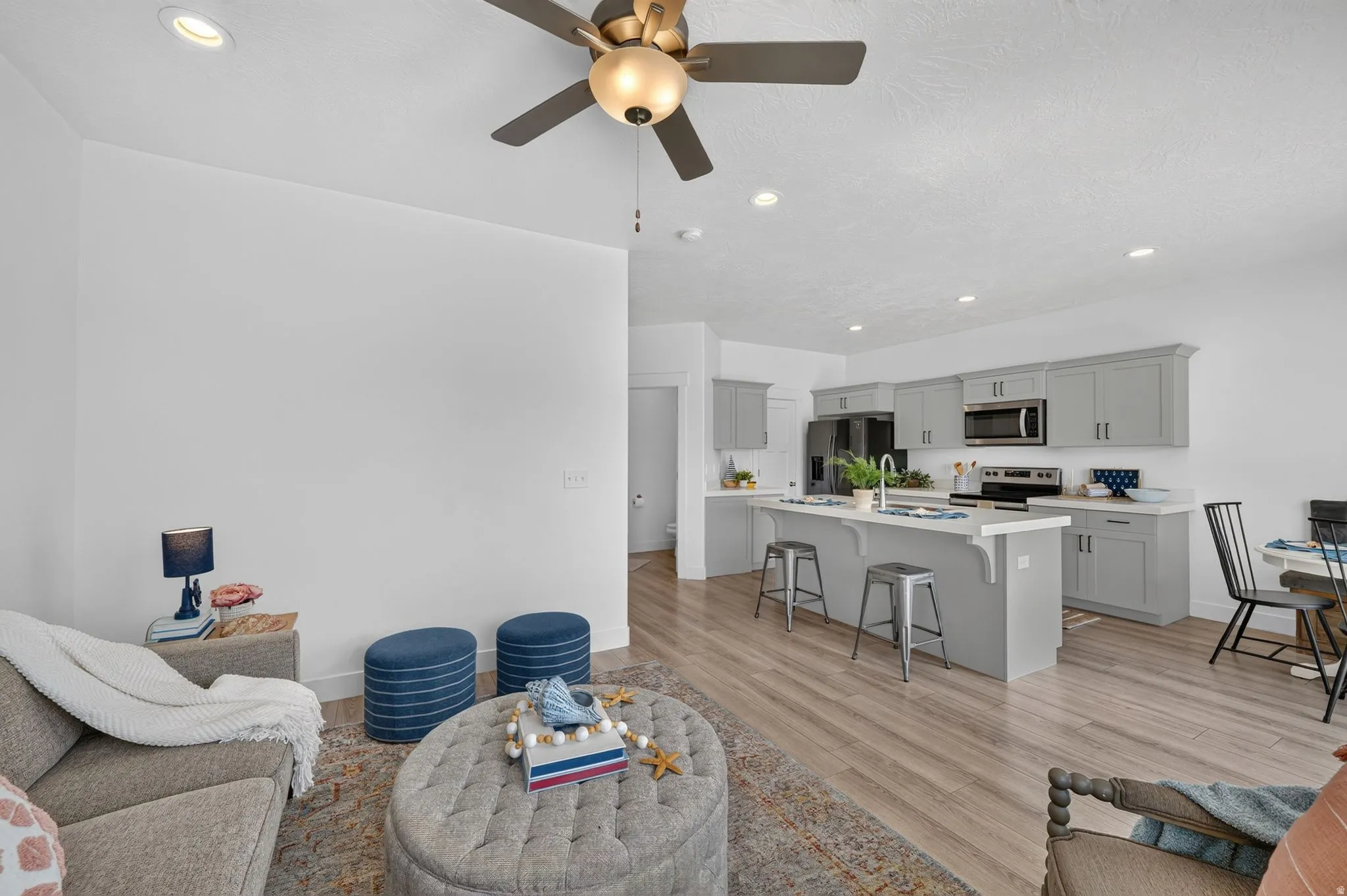 Open concept living area featuring wood-finish flooring