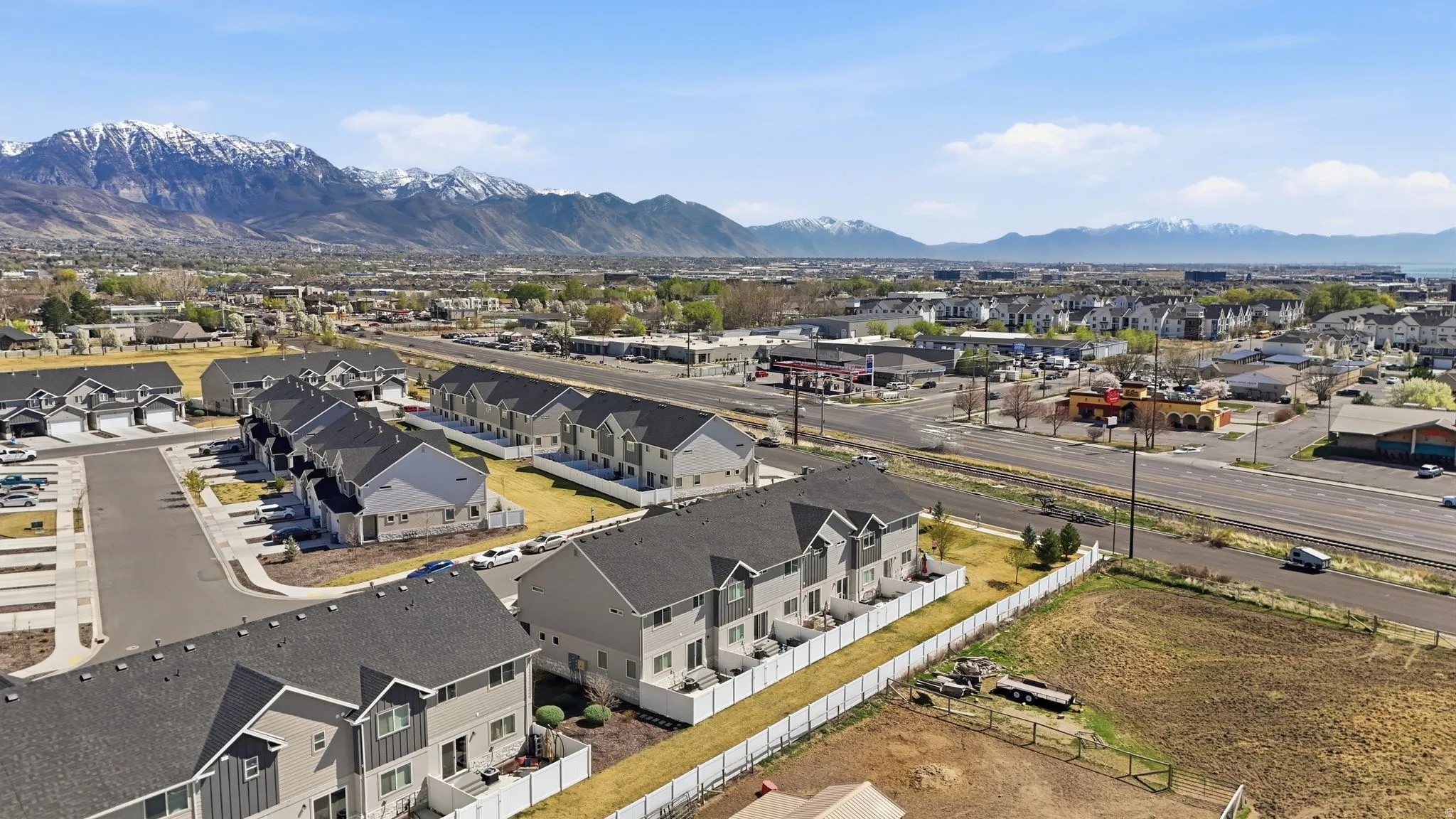 New construction townhomes with mountain backdrop and established neighborhood surroundings