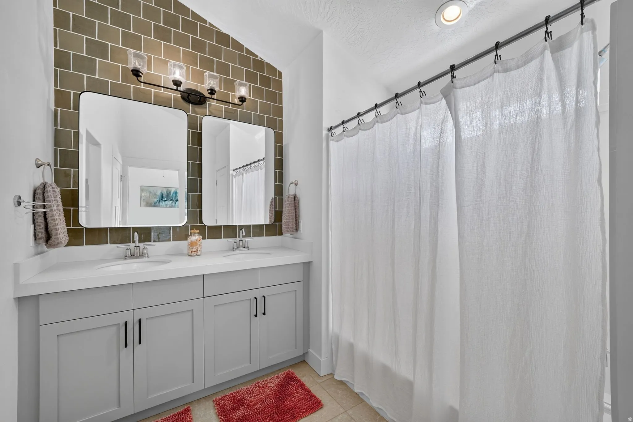 Dual vanity with a white countertop and rectangular undermount sinks