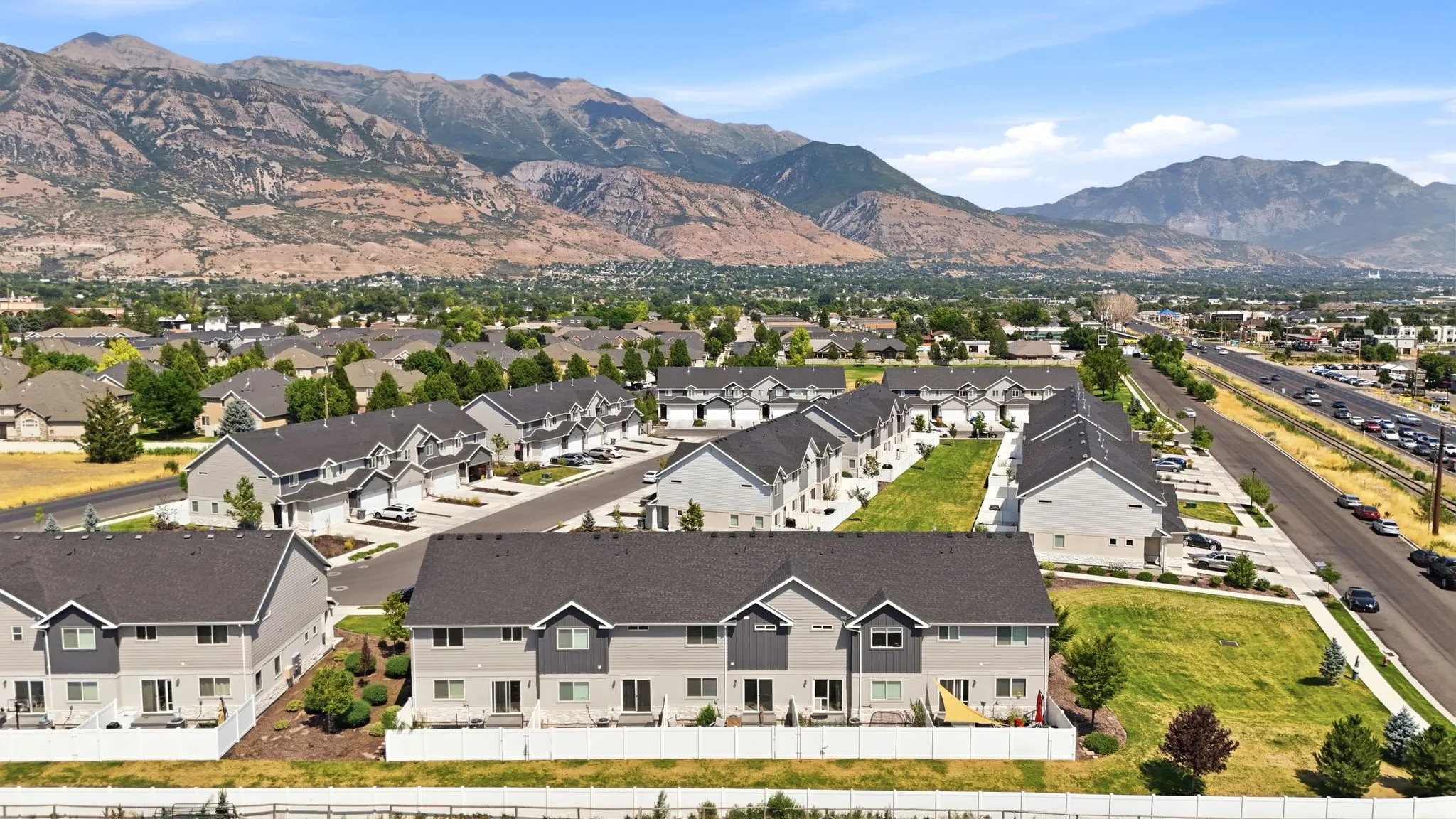 Community of townhomes set against a mountainous backdrop