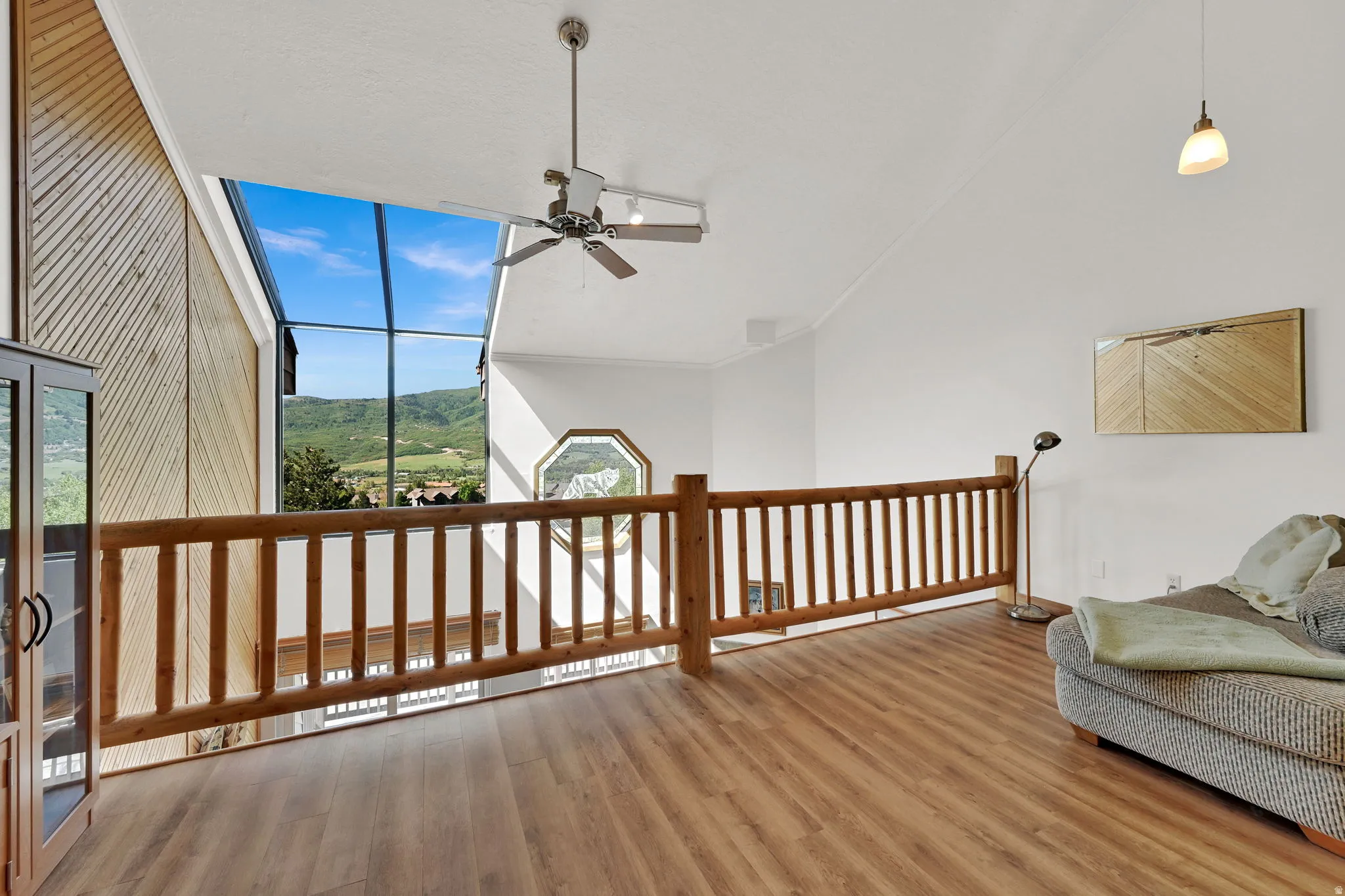 Expansive windows frame a mountain backdrop from this upper-level interior