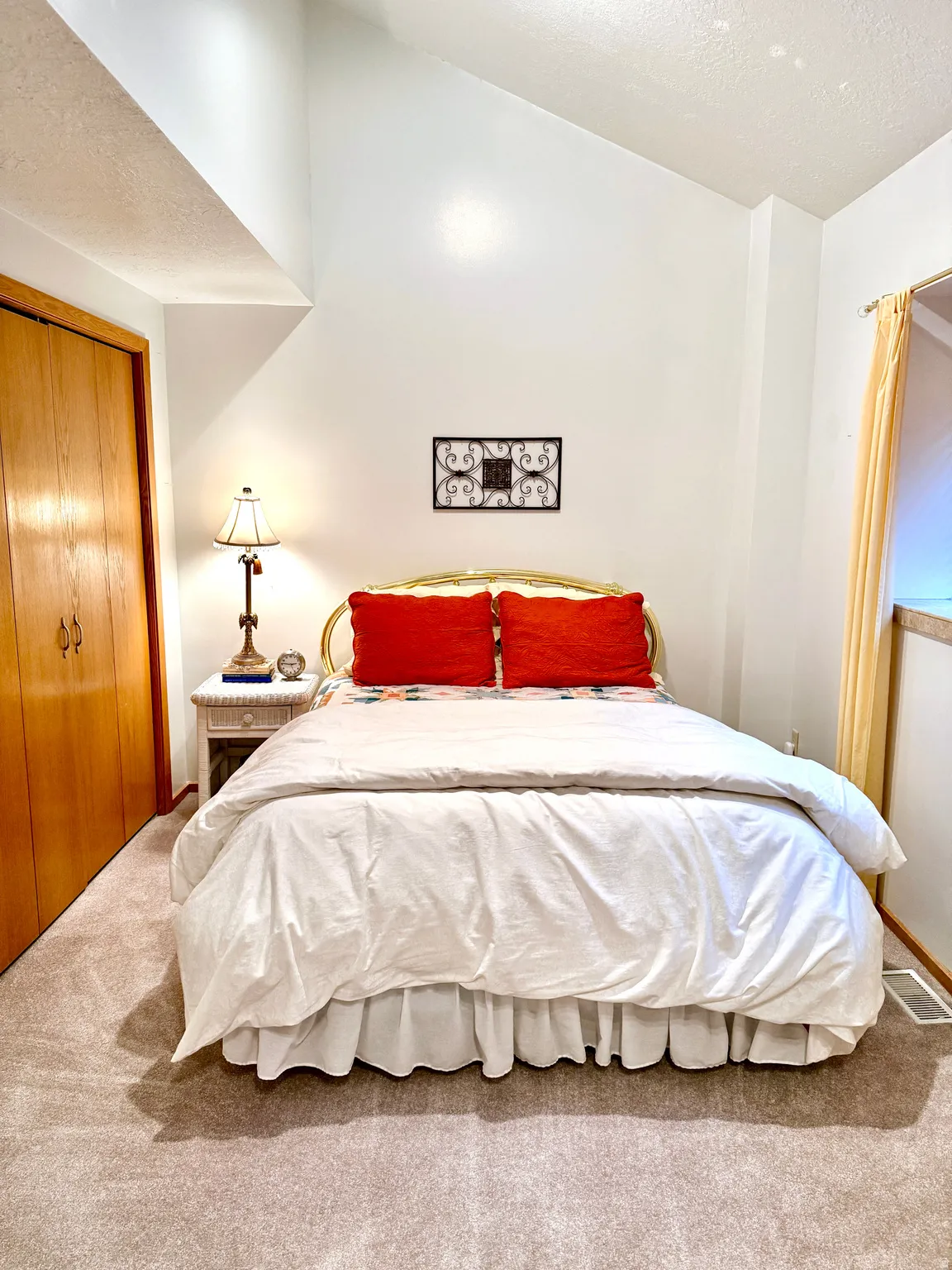 Room featuring a vaulted ceiling and light-colored carpeting