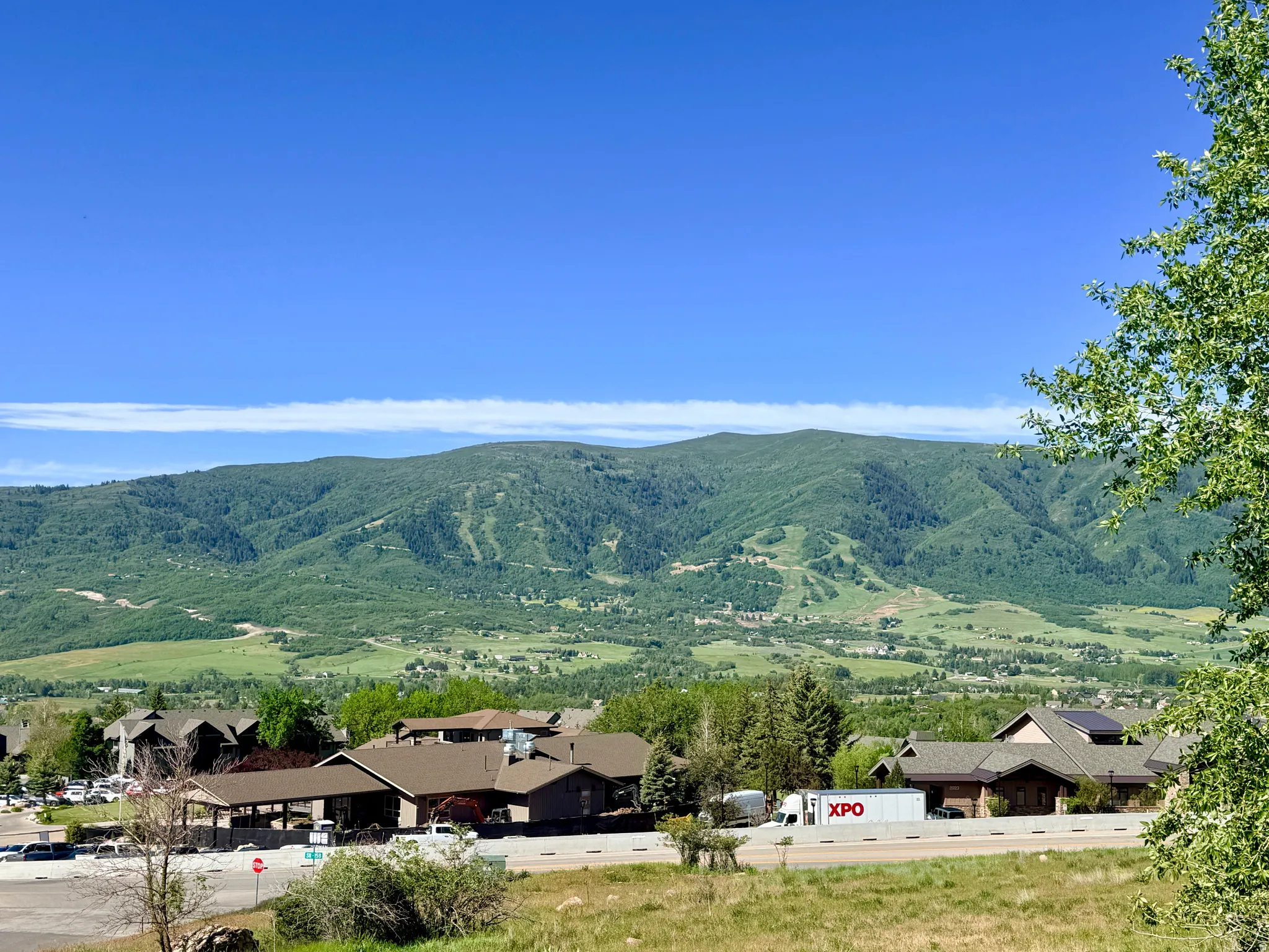 West View from Deck. Expansive mountain landscape with tree-covered slopes