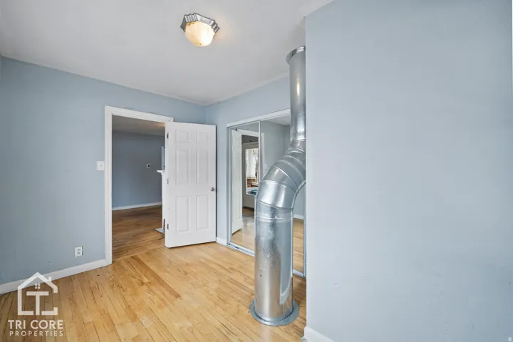 Hardwood flooring throughout, with light blue wall finishes