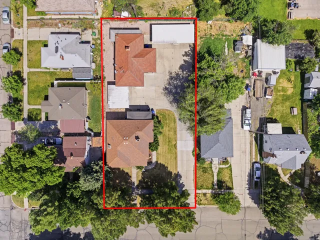 Aerial overview showcasing the property with two structures and expansive paved areas