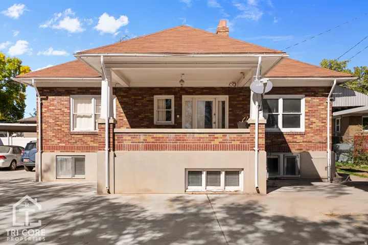 Brick exterior with a covered porch featuring white columns