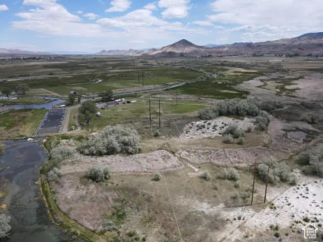 Expansive land parcel featuring natural waterways and distant mountain ranges
