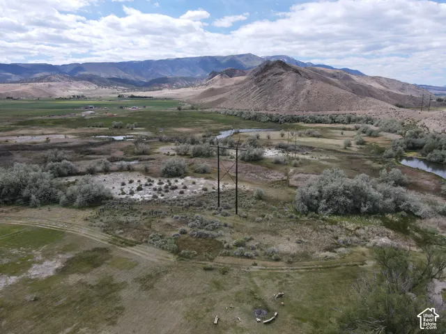 Expansive natural landscape featuring rolling hills and distant mountains