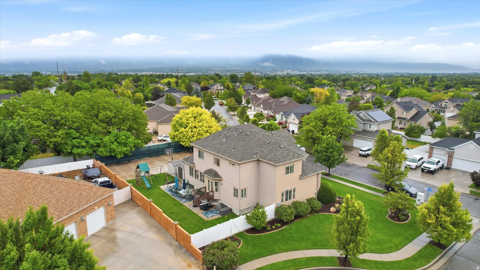 Aerial perspective showcasing the residential neighborhood with a large, private backyard
