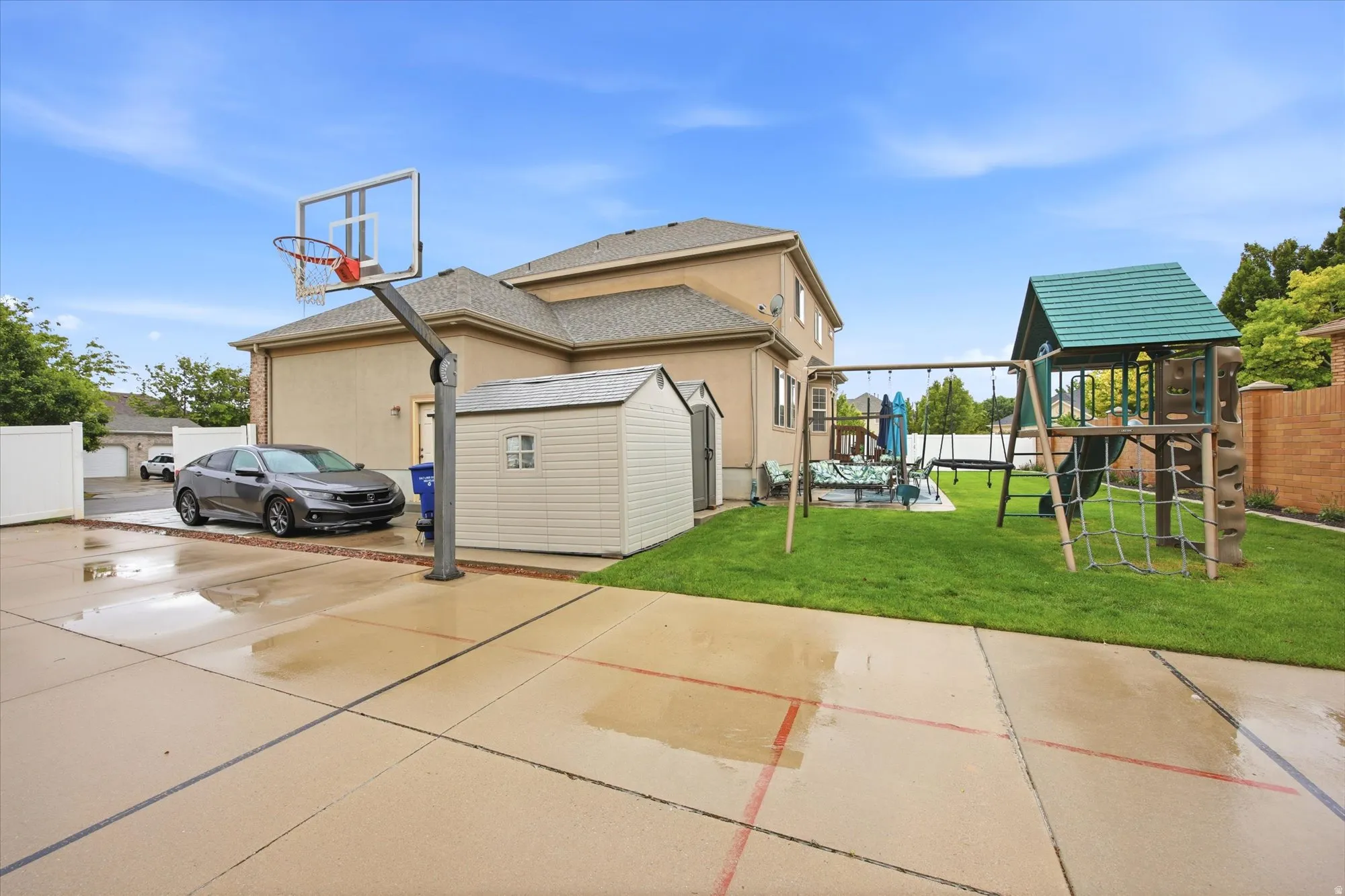 Expansive concrete patio with integrated basketball hoop