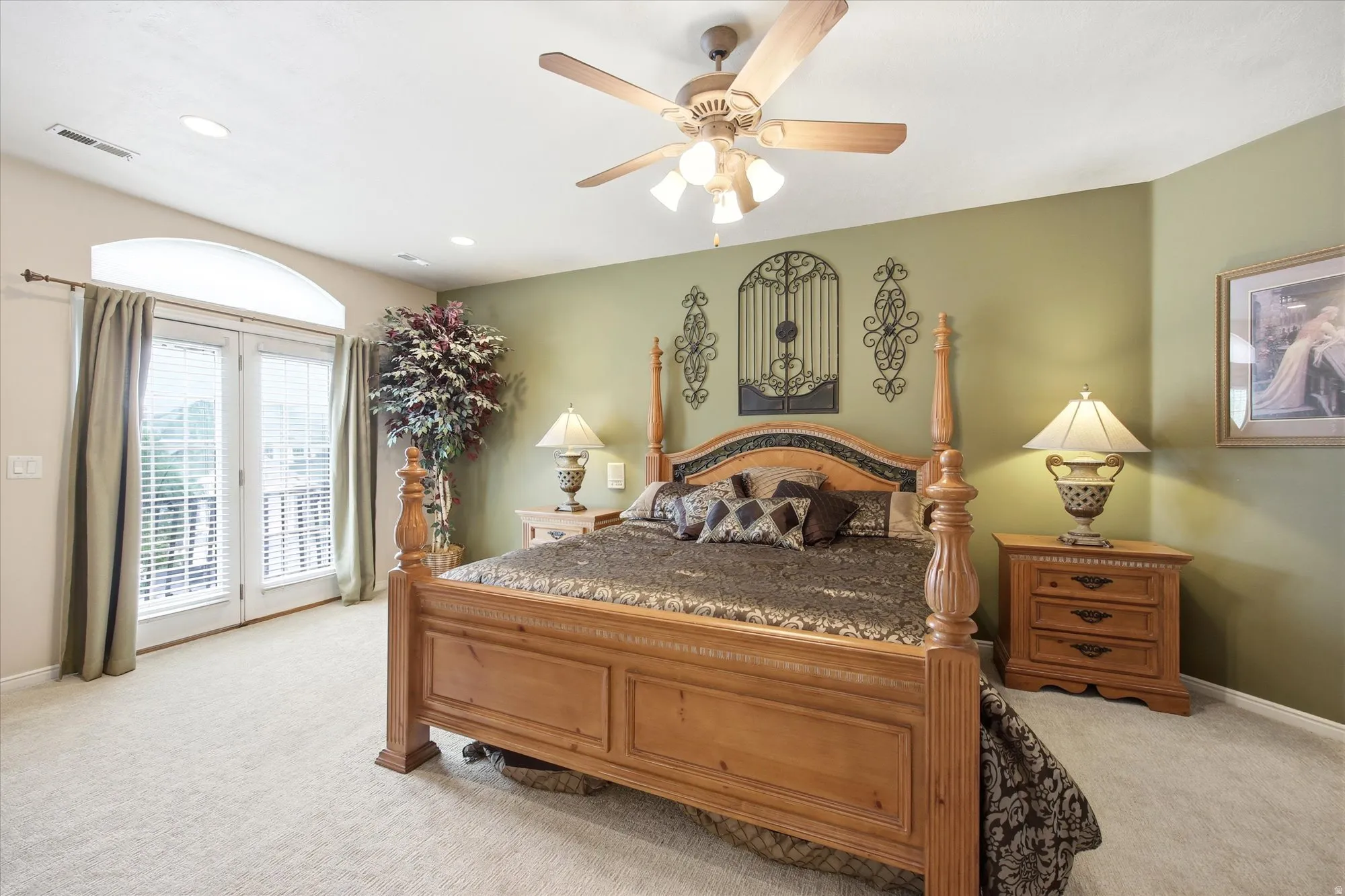 Carpeted bedroom with a vaulted ceiling and recessed lighting