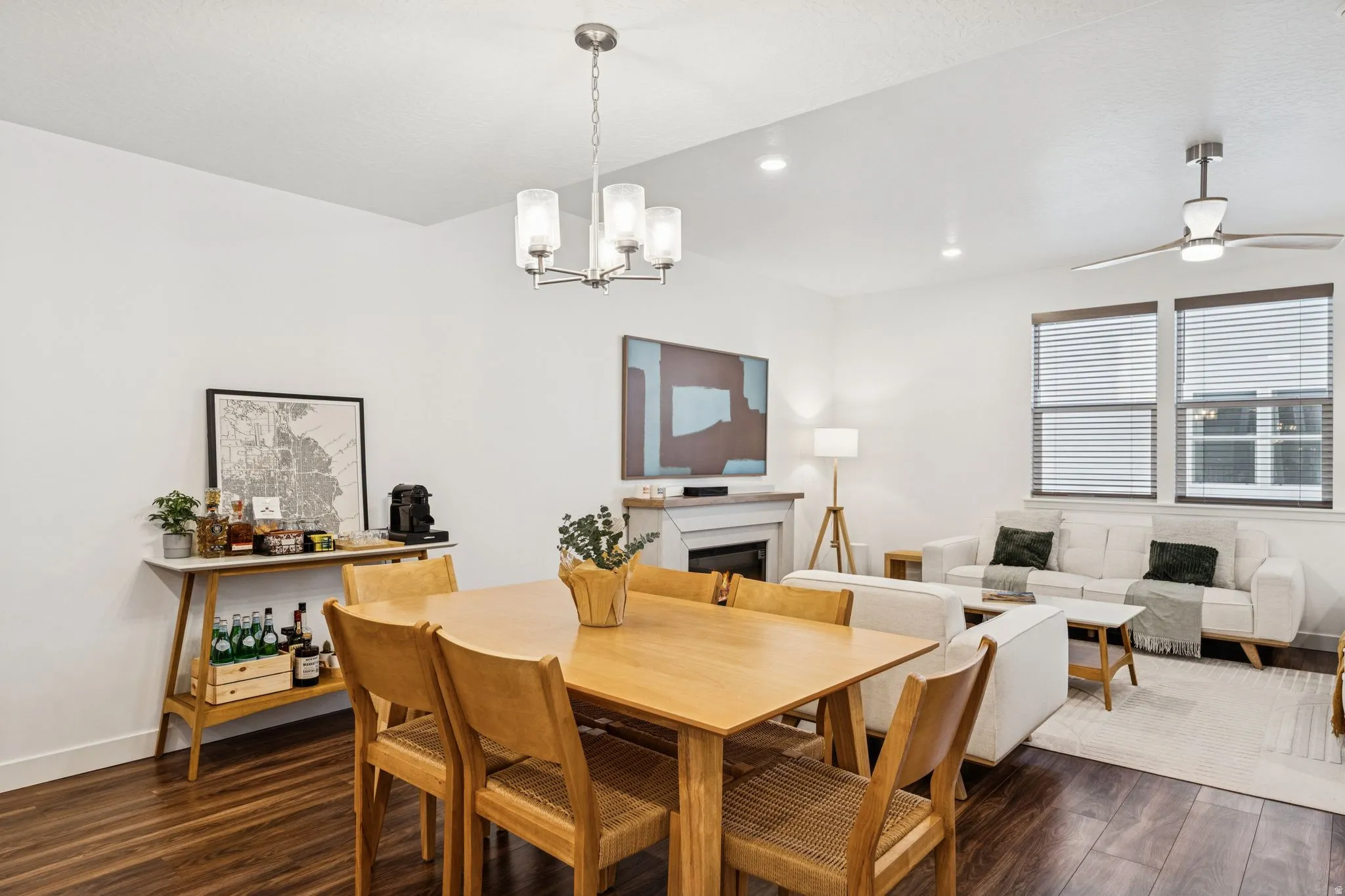 Open-concept living space featuring wood-finish flooring, recessed lighting, and a modern ceiling fan