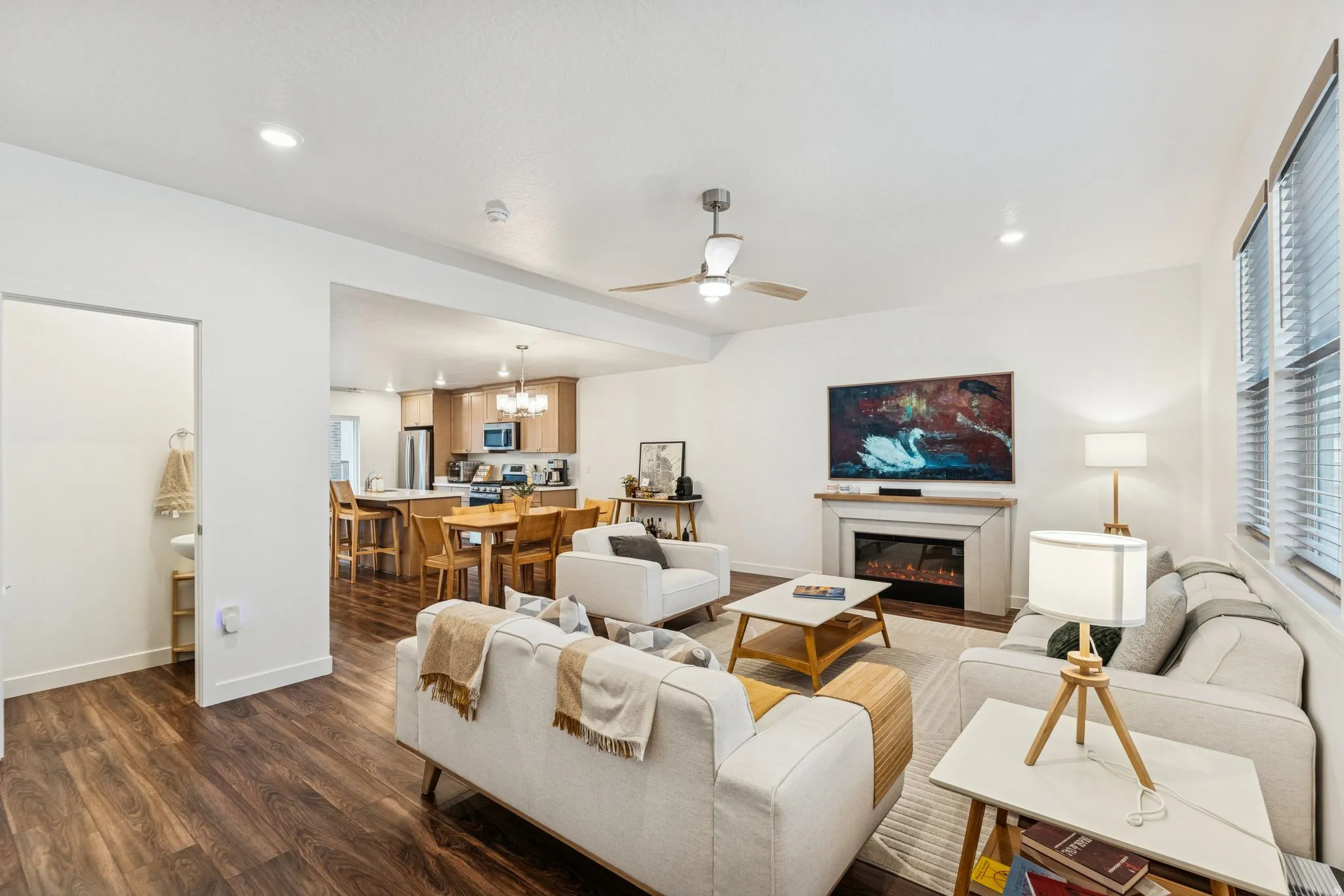 Bright living space featuring wood-finish flooring, recessed lighting, and a modern ceiling fan