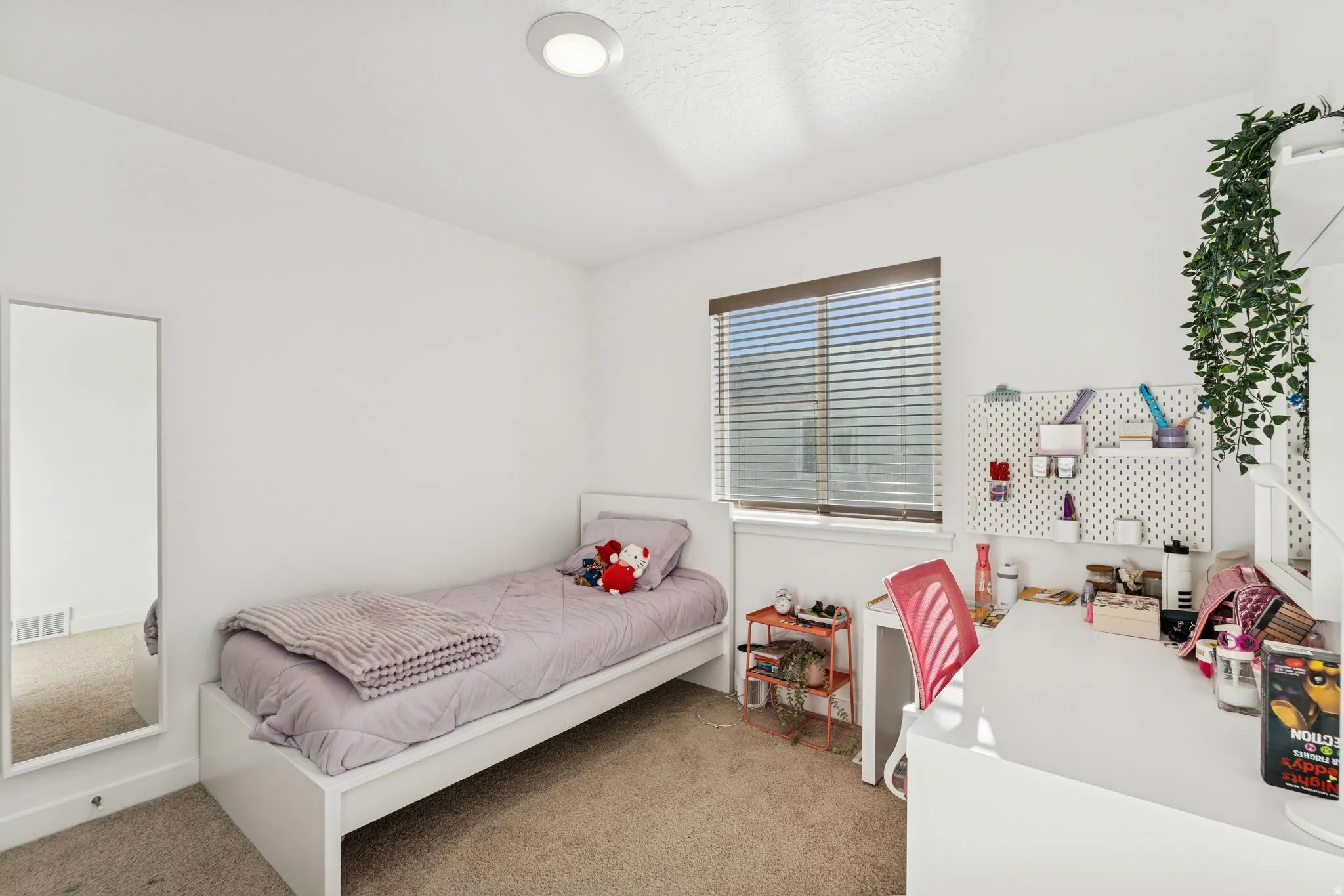Carpeted room with a window featuring horizontal blinds, recessed ceiling lighting, and white baseboards