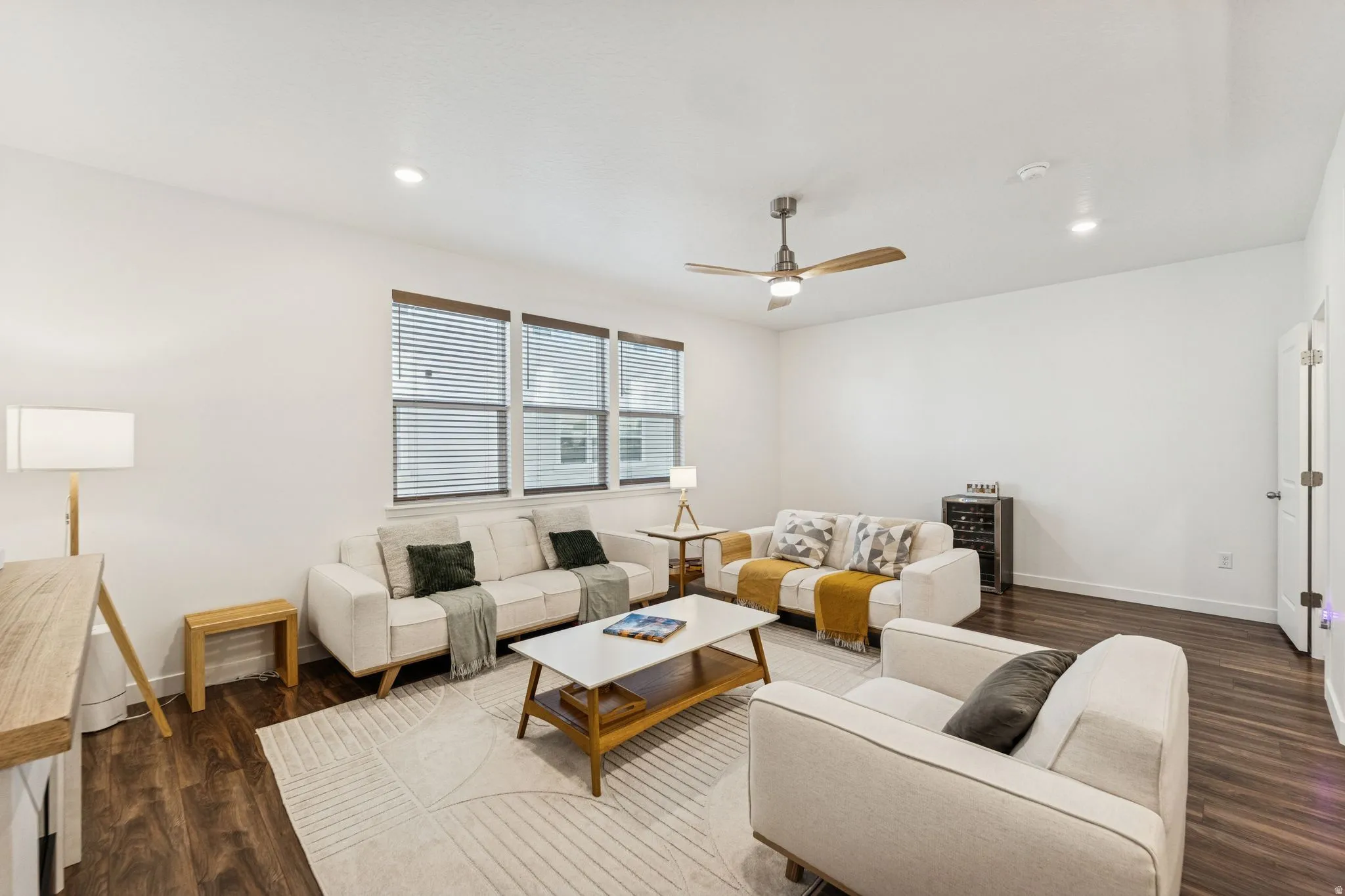 Bright living area with recessed lighting and a ceiling fan