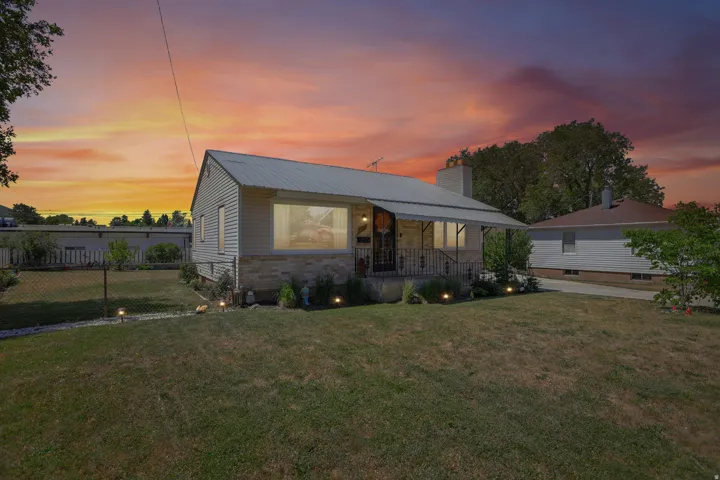 Single-story residence featuring siding and stone exterior