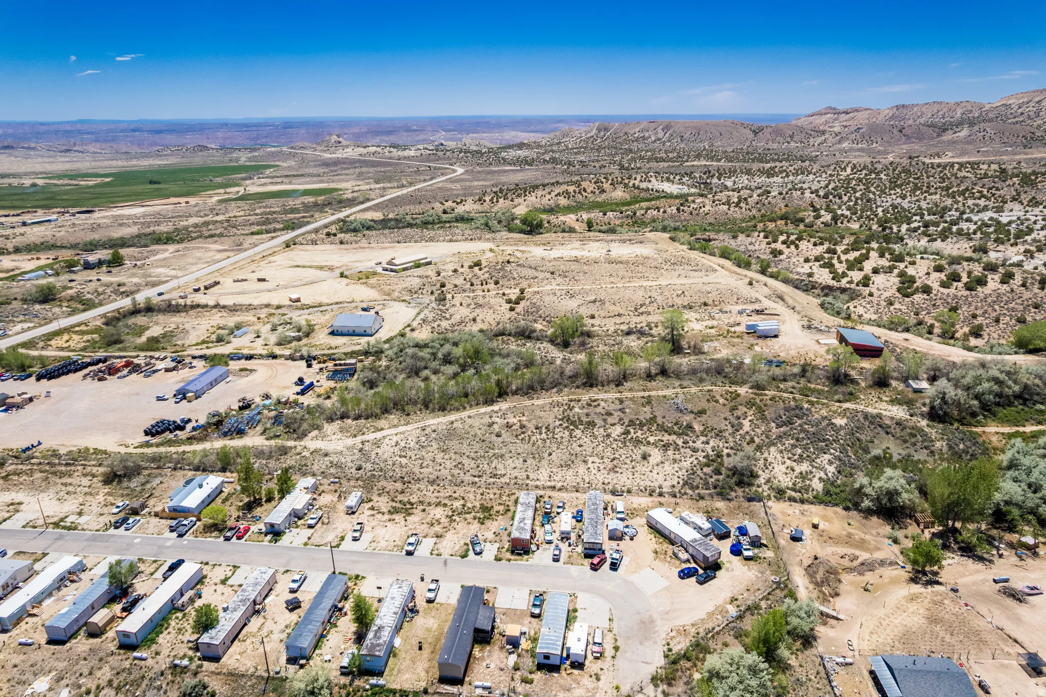 Aerial perspective showcasing expansive desert terrain with scattered vegetation