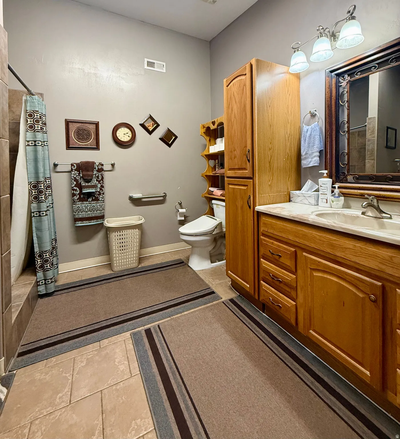 Neutral-toned tile flooring complements the light gray wall finish