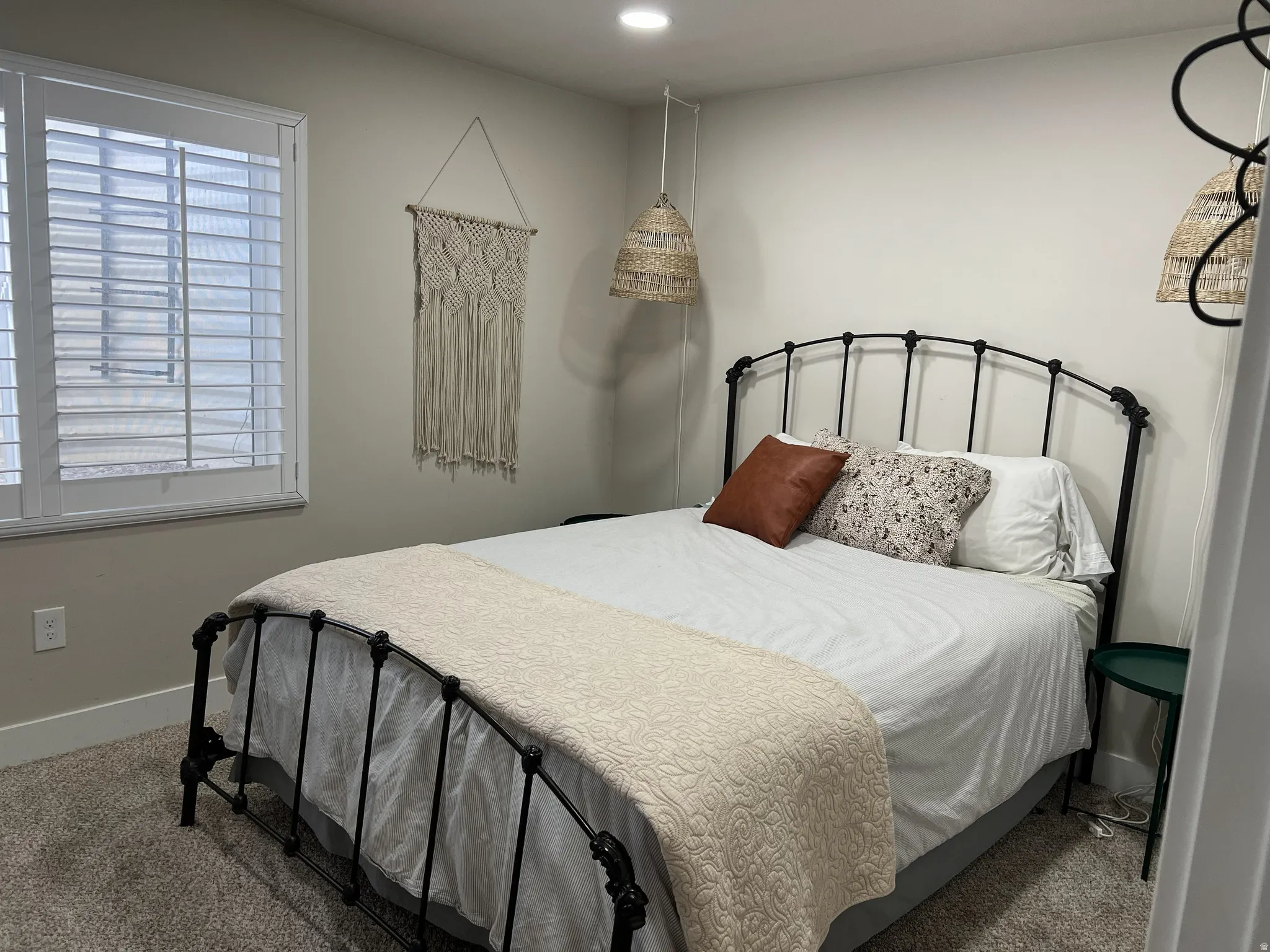 Carpeted bedroom featuring white walls, a window with white plantation shutters, white baseboards, and recessed ceiling lighting