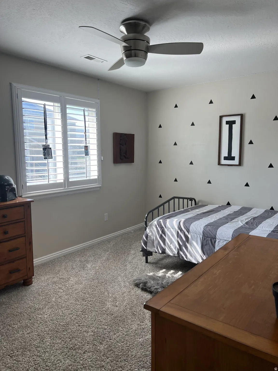 Recessed lighting, ceiling fan with integrated light fixture, window with plantation shutters, baseboard molding, and textured wall finish