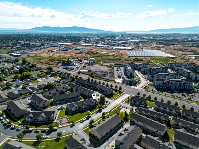 Aerial view showcasing a residential community with townhomes and apartment buildings