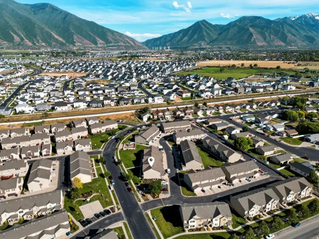Aerial perspective showcasing a residential community with distant mountain ranges