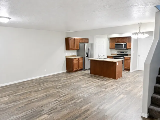 Open-concept living space featuring wood-finish flooring