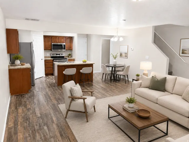 Open-concept living space with wood-finish flooring throughout AI Staged