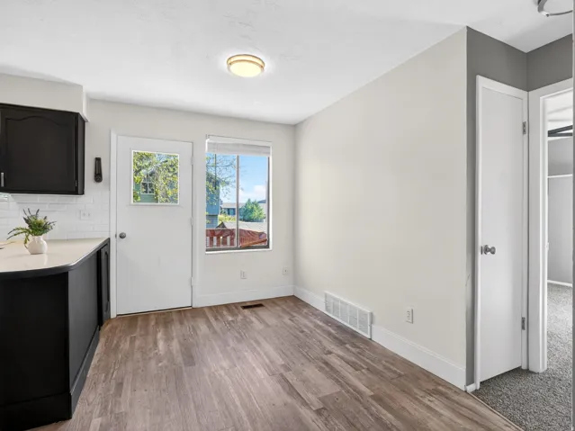 Kitchenette space featuring wood-finish flooring, white walls, and a recessed ceiling light