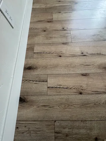 Wood-finish plank flooring with varied grain patterns and a matte finish