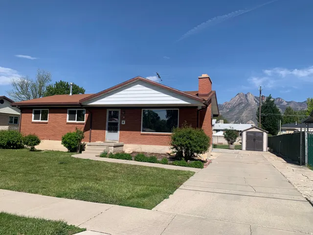 Brick exterior featuring a gabled roofline and white siding accents