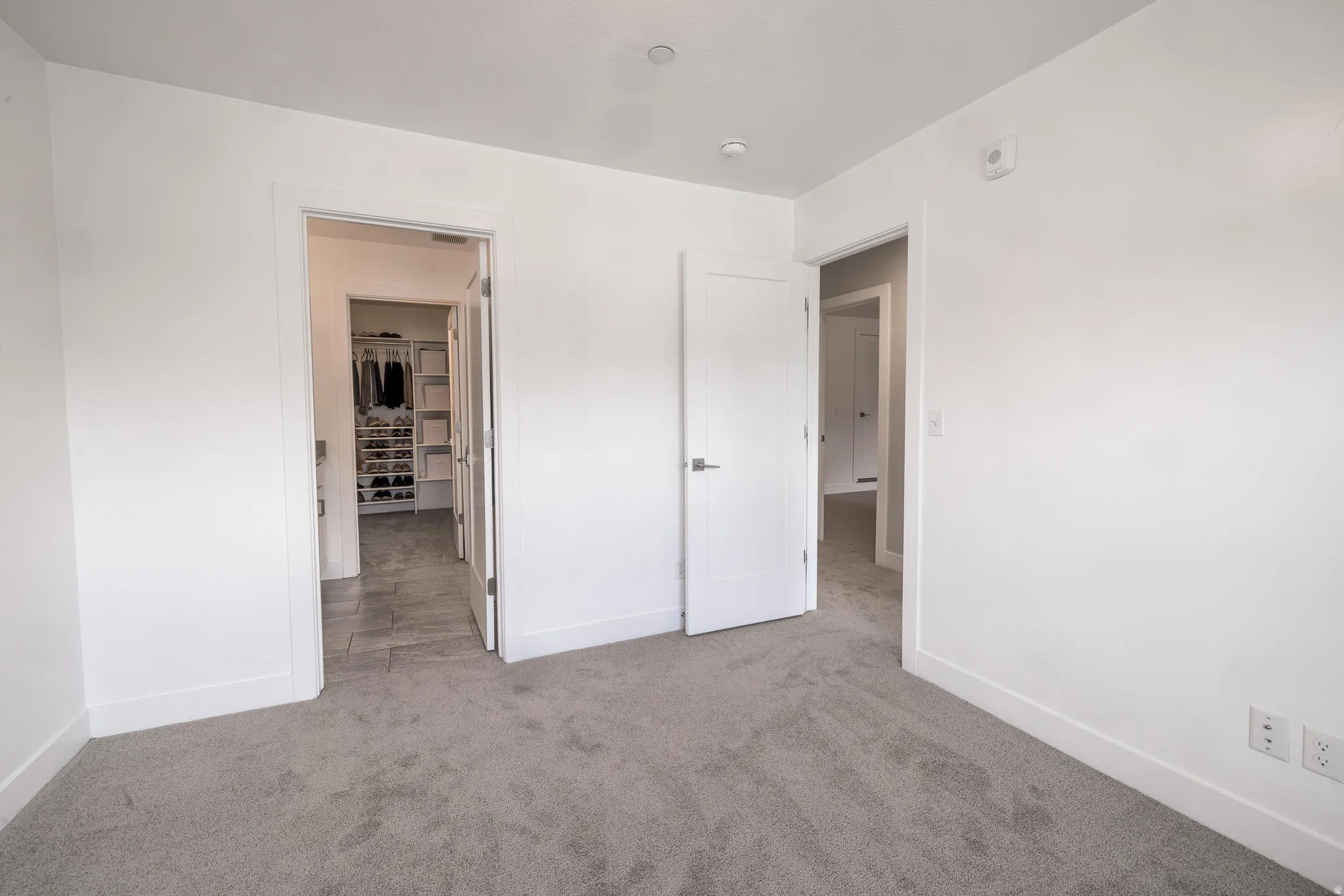 Bright interior space with light gray carpeting and white walls