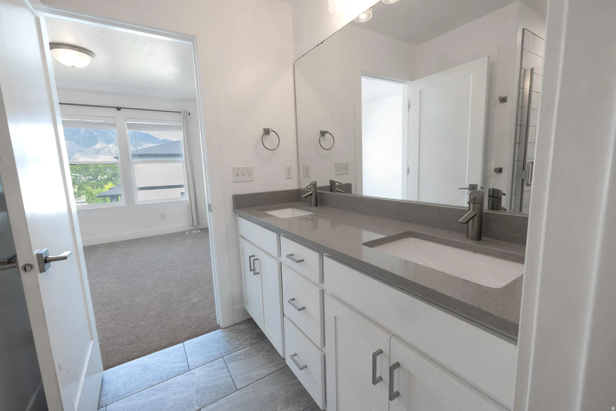 Dual vanity with integrated sinks and a stone-finish countertop