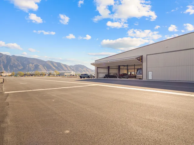 Industrial-style hangar with metal siding and a large bifold door