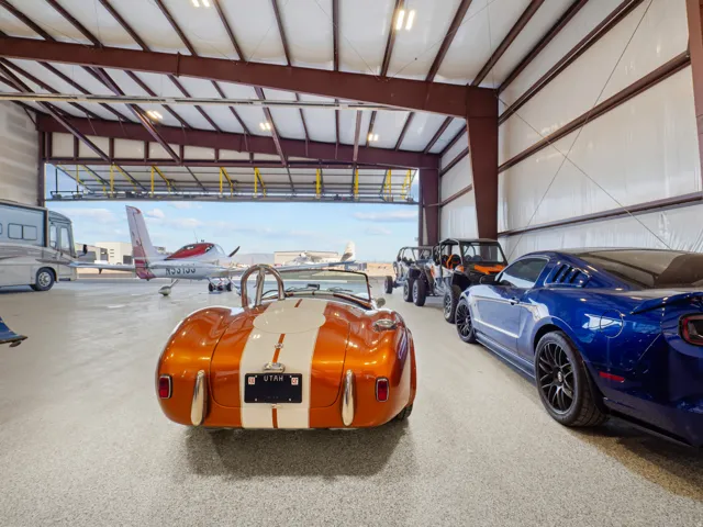 Spacious hangar featuring an epoxy-coated concrete floor and a large roll-up door