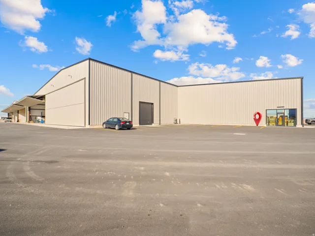 Expansive commercial building featuring corrugated metal siding and a dark trim