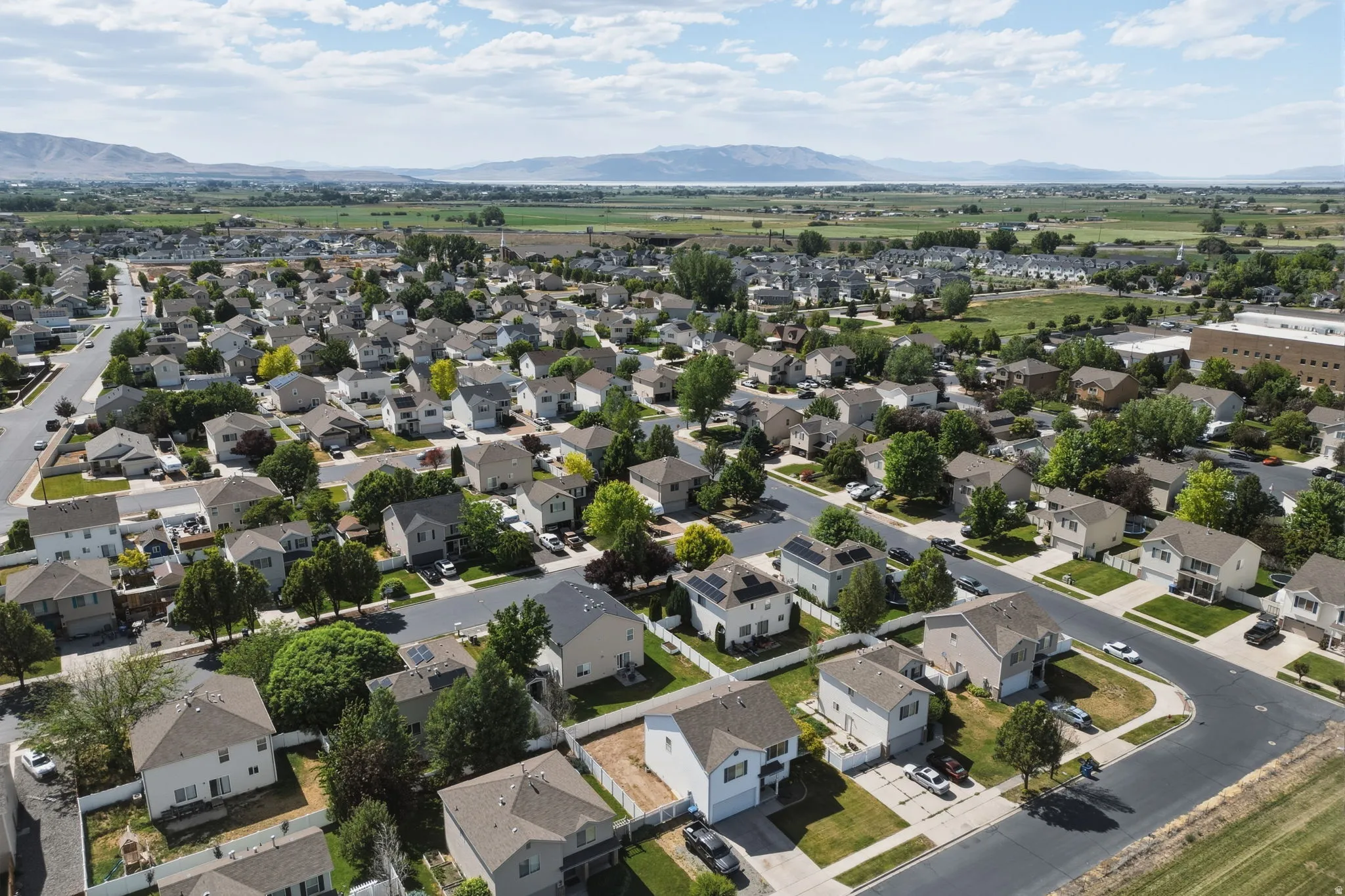 Aerial perspective showcasing a residential neighborhood with varied home styles and mature landscaping