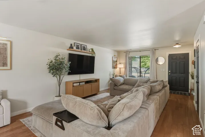 Open-concept living area featuring wood-finish flooring and light neutral wall colors