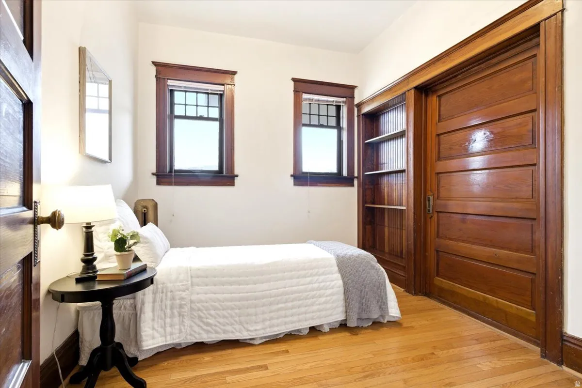 Hardwood flooring complements rich wood trim and a panel door